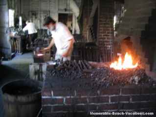 Colonial Williamsburg - Blacksmith pounding out square nails.